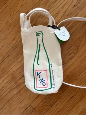 kate spade cream canvas wine tote with green bottle and pink label